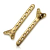 Two gold-colored Condylar Buttress Locking Plates with widened ends and rows of shaft openings